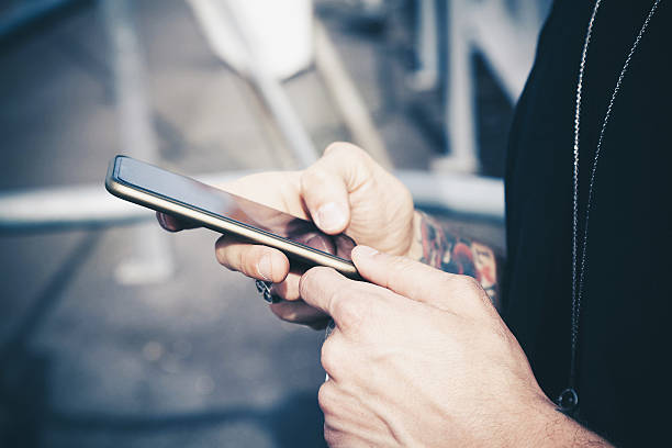 Male hands typing on smartphone